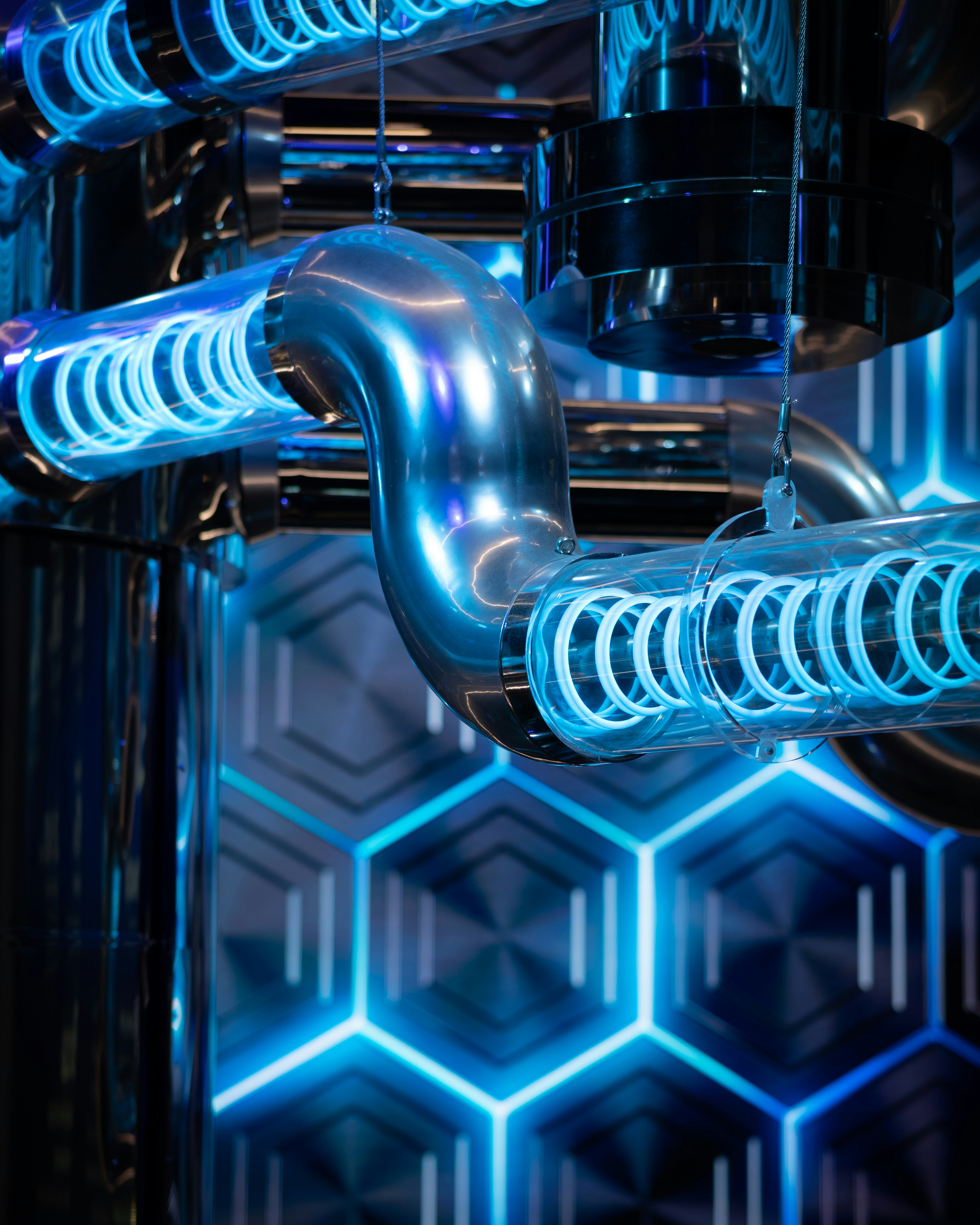 futuristic industrial piping with blue neon hexagonal lighting